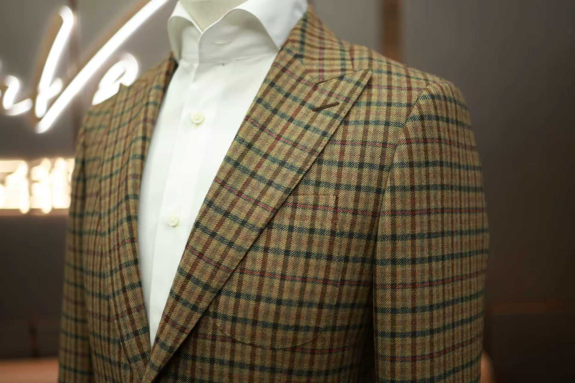 Man in premium bespoke suit, professional studio photography, dark background